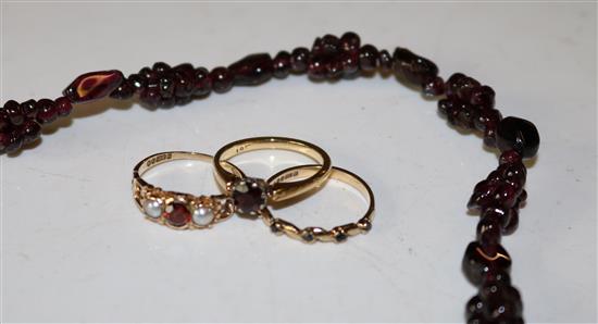 Three garnet rings and a garnet necklace